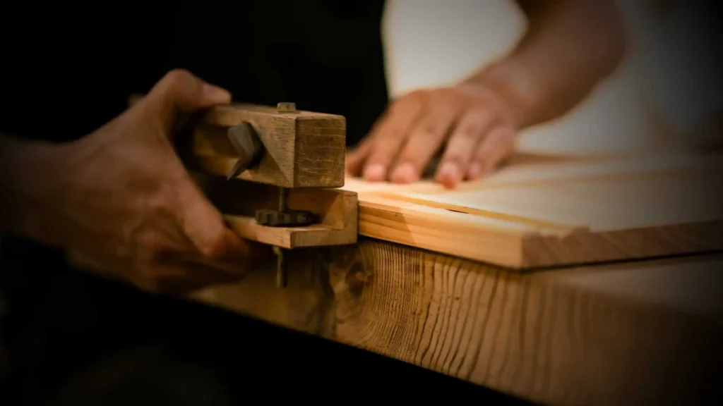Boutique woodwork artisan testing dimensional accuracy during the B2B purchase order inspection at a premium wood panel manufacturing facility.