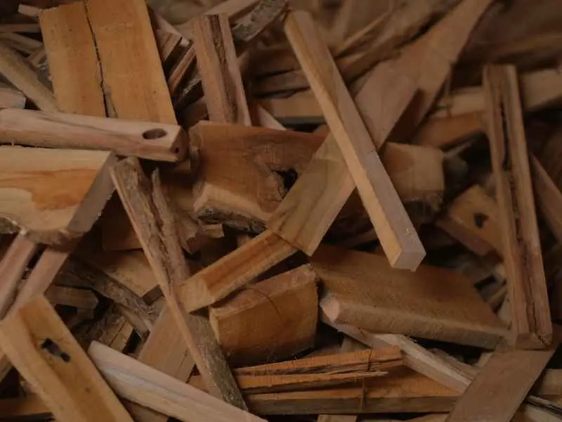 Premium reclaimed teak wood offcuts and mill residues sorted for upcycled 3D wood wall panels production